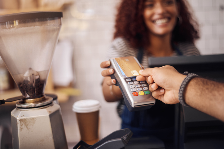 Closeup shot of a customer making a credit card payment in a cafe