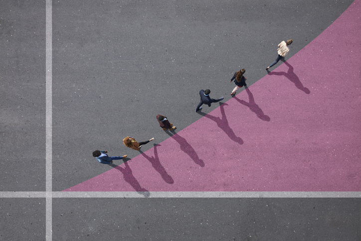 Group of young adults, photographed from above, on various painted tarmac surface, at sunrise.