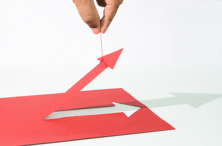 Human hand pulling up a red arrow.