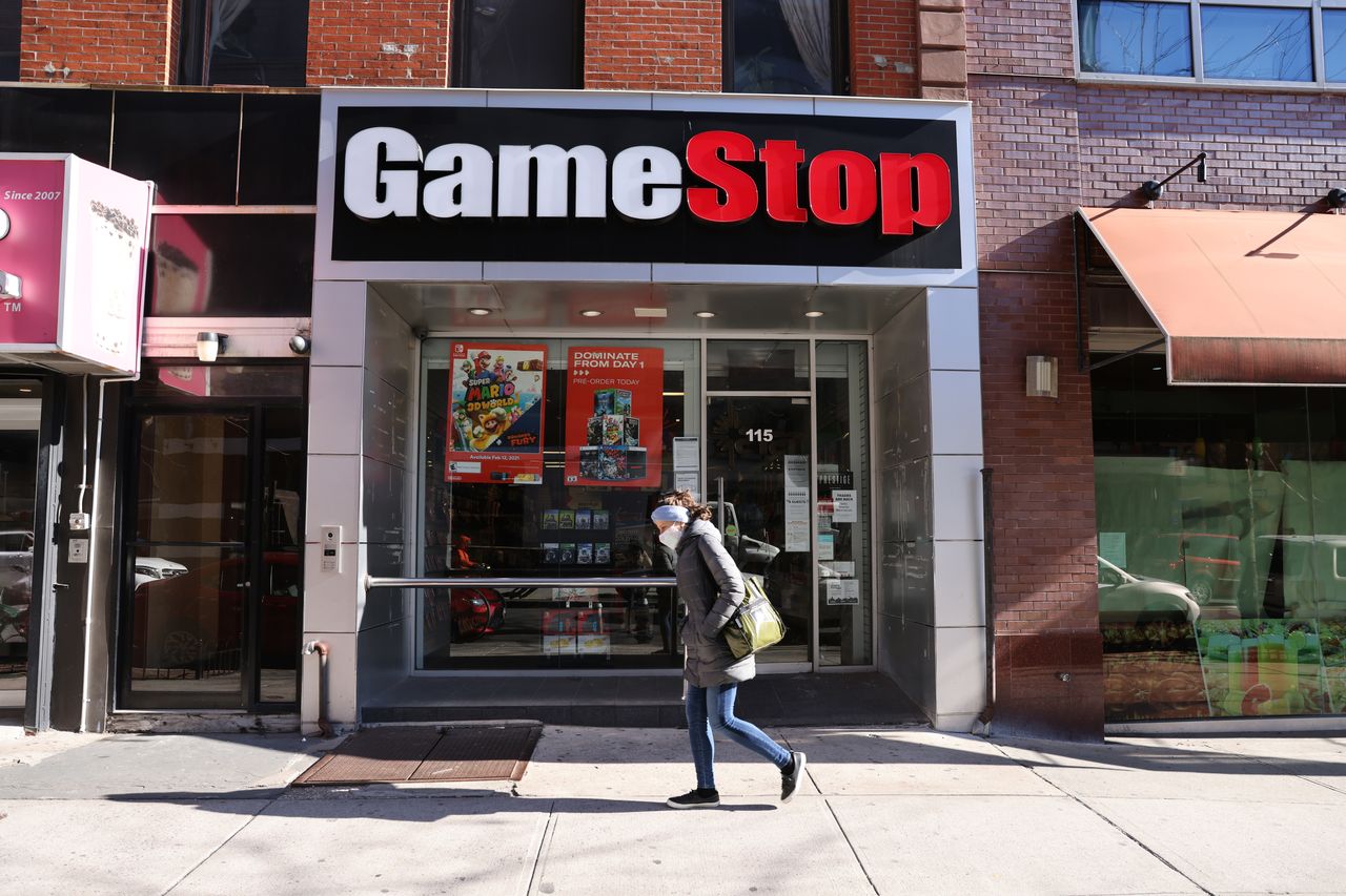 NEW YORK, NEW YORK - JANUARY 28: People walk by a GameStop store in Brooklyn on January 28, 2021 in New York City. Markets continue a volatile streak with the Dow Jones Industrial Average rising over 500 points in morning trading following yesterdays losses. Shares of the video game retailer GameStop plunged. (Photo by Spencer Platt/Getty Images)