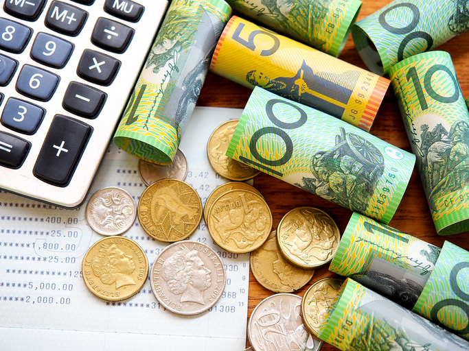 Australia bank note,coins,account book and calculator in top view