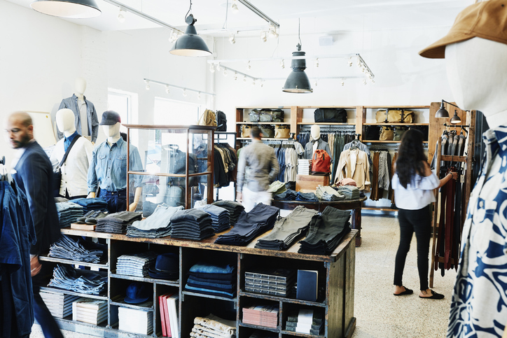 Shoppers looking at items in mens clothing boutique
