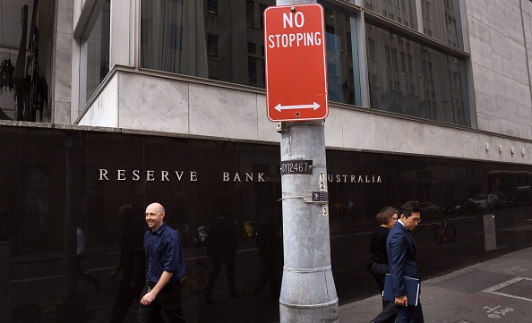 People walk past the Reserve Bank of Australia building in Sydney on March 6, 2018, as Australia's central bank kept interest rates at a record in a widely expected decision with wages growth still weak and inflation below target. - The Reserve Bank of Australia has not adjusted rates since August 2016, following a series of cuts from November 2011 that took it to 1.50 percent in a bid to boost non-mining sectors of the economy. (Photo by William WEST / AFP) (Photo by WILLIAM WEST/AFP via Getty Images)